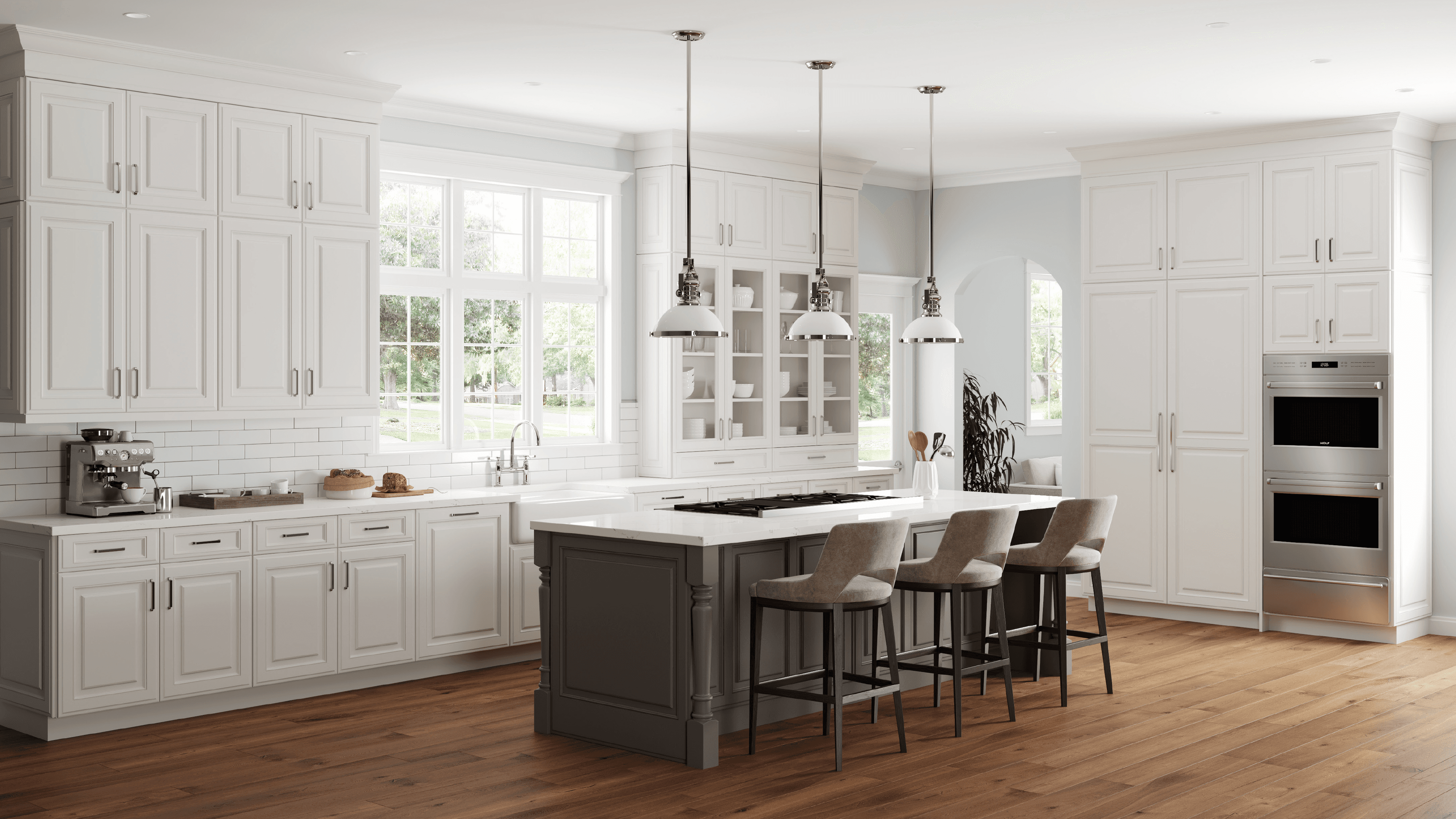 Modern kitchen featuring white cabinetry, a grey island with bar stools, and hardwood floors.