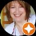 Smiling woman with brown hair in a circular profile picture with an orange star badge.